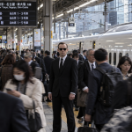 Agent Smith from The Matrix standing at Tokyo Station